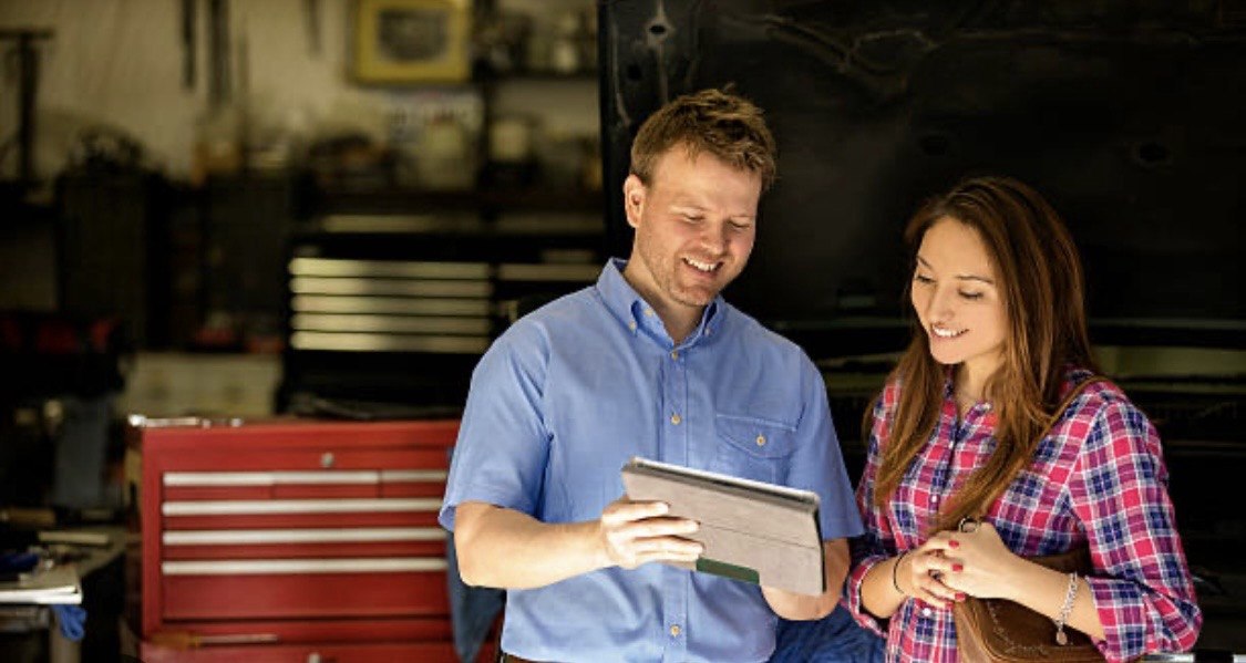 Service advisor reviewing repair details with customer